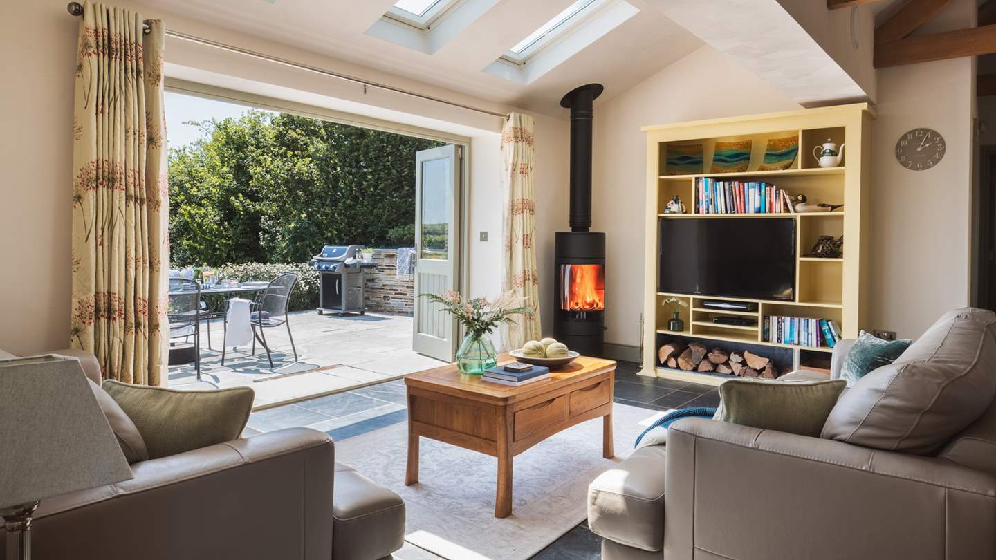 The bi-fold doors bring the outside in on warmer days - and there's a wood-burner for chillier days, perfect!