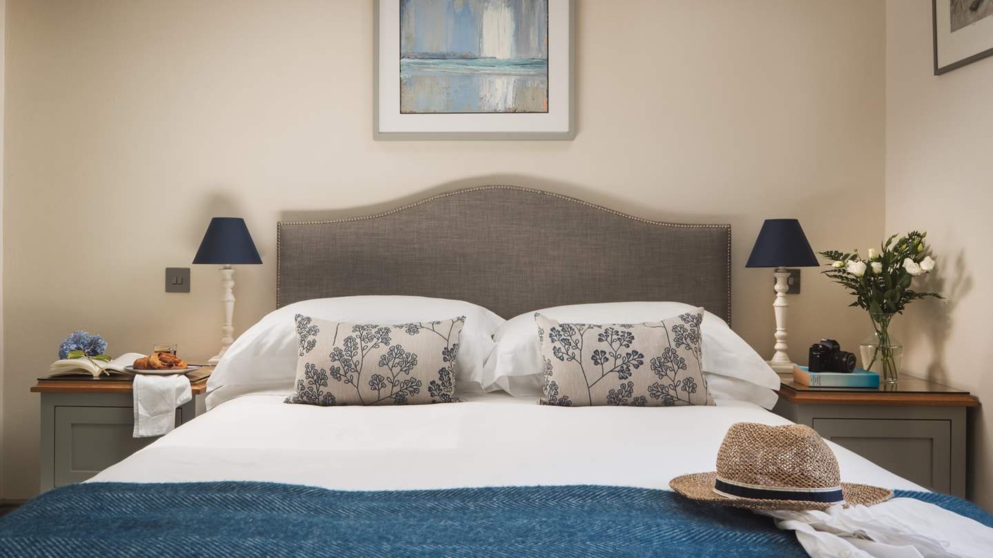 Decorated in soothing hues this bedroom promises moments of comfort and calm