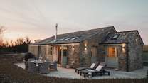 Nestled snugly amongst rolling Cornish hills, our dog-friendly converted barn close to Padstow promises endless bucolic charm...