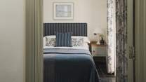 Slip softly into the king-sized bed, swathed in luxurious linens, soft bedding
