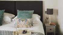 Slip softly into the king-sized bed, swathed in luxurious linens, soft bedding